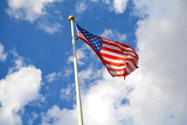 American flag in the blue sky