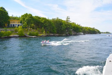 Tourists on a boat on St. Lawrence River clipart