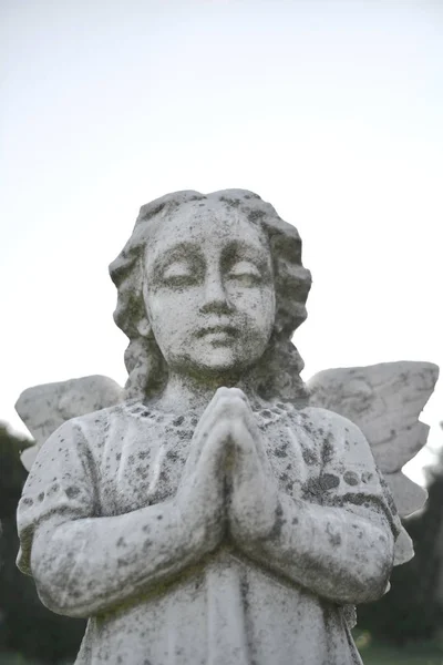 Vintage image of a sad angel on a cemetery.