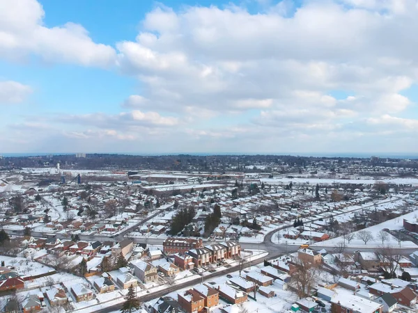 Snow view from the top with urban city, aerial photography over the suburb. Winter scenery of the american city from the bird eye.