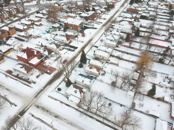 Snow view from the top with urban city, aerial photography over the suburb. Winter scenery of the american city from the bird eye.