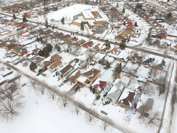 Snow view from the top with urban city, aerial photography over the suburb. Winter scenery of the american city from the bird eye.