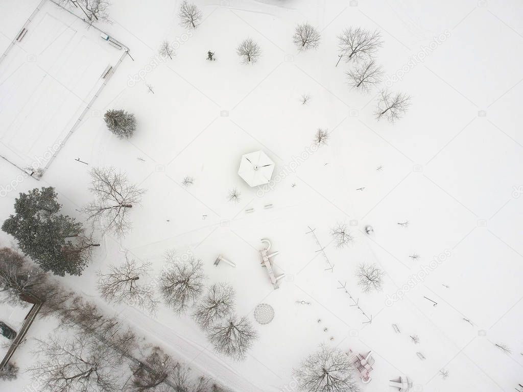 High level of snow and snow storm winter weather forecast alert day in the city. Top aerial view of the kids playground from the bird view. Children's park is covered in thick layer of snow. Canada. 