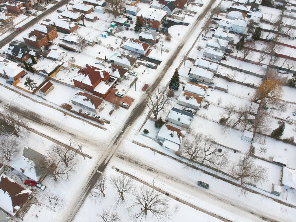 Snow view from the top with urban city, aerial photography over the suburb. Winter scenery of the american city from the bird eye. 