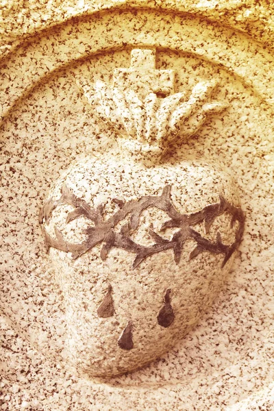 Sacred heart medallion with crown of thorns and blood in stone. — Stock Photo, Image