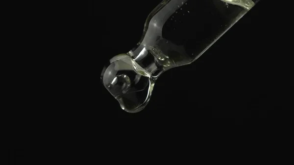 Oil or liquid dropper or pipette in extreme macro close up. Drop — Stock Photo, Image