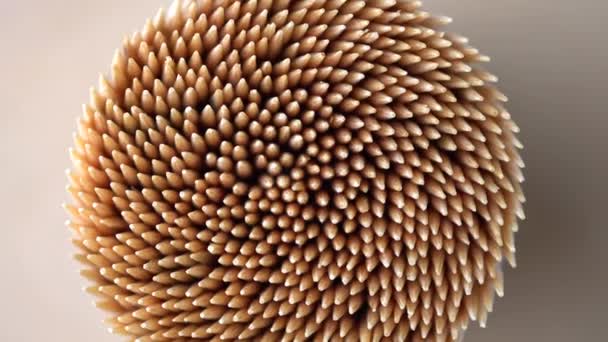 Wooden toothpicks or cocktail sticks extreme close up. Hand picks made of bamboo macro shoot of rotation. Concept of teeth hygiene or oral tooth care. Caries prevention. Dental healthcare. — Stock Video