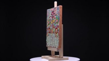Canlı sanat eserleri soyutlamada işe yarar. Şövalenin üzerinde modern stil çiçekli resim rotasyonu. Ev ya da apartman dekorasyonu ve yenileme konsepti. Duvara asmak için çiçek boyası.