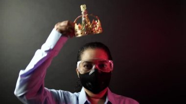 Woman in urban protective air mask with glasses, wearing crown or corona. Coronavirus pathogen outbreak pandemic concept. Virus disease 2019-nCoV or covid-19 protection and prevention. 4k