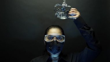 Coronavirus pathogen outbreak pandemic concept. Woman in urban protective air mask and glasses wearing crown or corona. Virus disease 2019-nCoV or covid-19 coronavirus protection and prevention. 4k