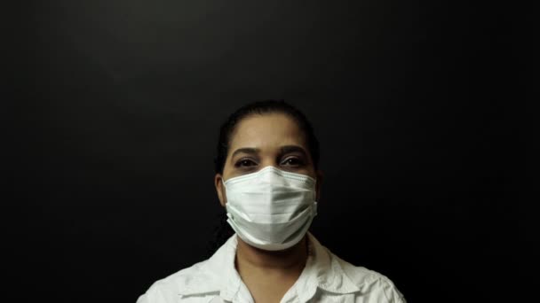 Woman in surgical or medical mask put on the crown on the head, depicting Coronavirus or covid 19, virus outbreak concept. Corona virus disease 2019-nCoV protection and prevention. 4k. — 비디오