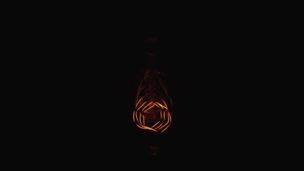 Tungsten light bulb lamp cozy turn on slowly over black background, macro close up shot of old retro vintage light bulb brighten light. Comfort cozy concept. 4k. — 비디오