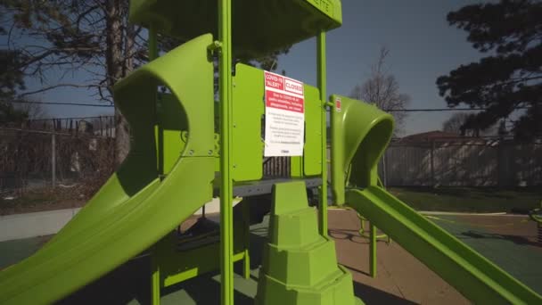 Toronto, Ontario, Canada - April 18, 2020 : Sign by city, COVID-19 ALERT CLOSED, all parks amenities, including, playgrounds, are closed. Practice physical distancing, two meters apart. Abandoned park — Stock Video