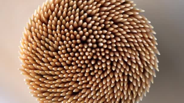 Wooden toothpicks or cocktail sticks extreme close up. Hand picks made of bamboo macro shoot of rotation. Concept of teeth hygiene or oral tooth care. Caries prevention. Dental healthcare. — Stock Video