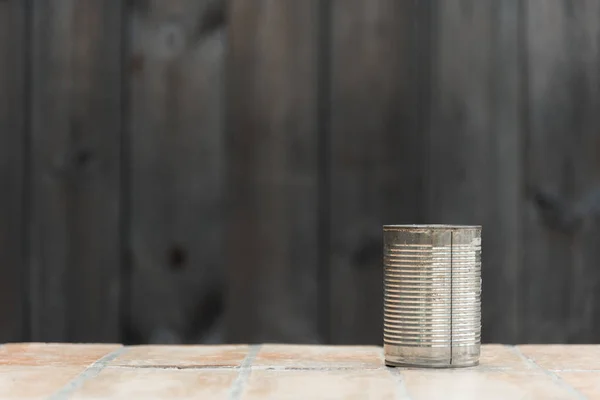 tin can on clay tile floor