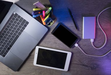 Dizüstü bilgisayar, akıllı telefon ve koyu ahşap arka plan tablet PC'de. Üstten Görünüm