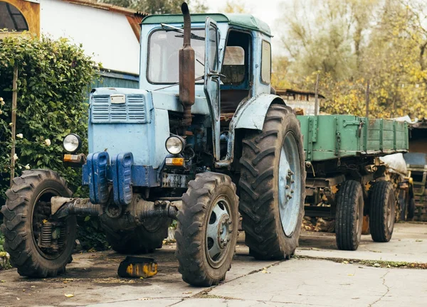 Old rusty tractor. Agricultural machine dilapidated front of the farm. Old iron. Tractor waiting to be scrapped. Abandoned farm