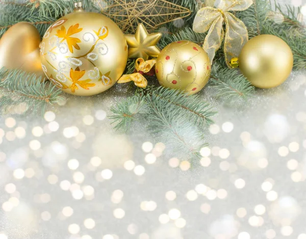 Yellow christmas tree decorations and a fir brach Stock Image