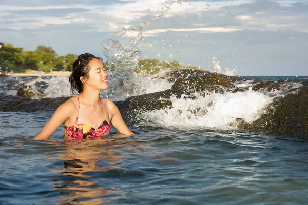 Woman enjoying last sunshine in water — Stock Photo, Image