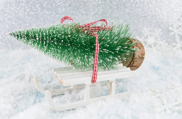Small sleigh carrying a Christmas tree — Stock Photo, Image