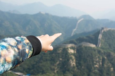 Female hand pointing the Great Wall of China clipart