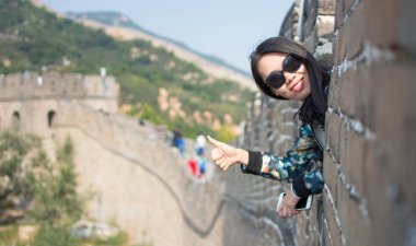 Happy tourist on the Great Wall of China clipart