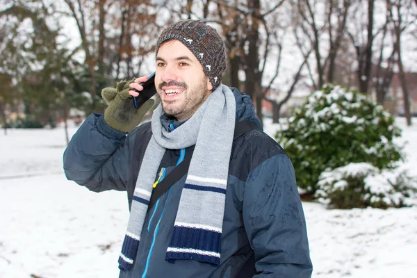 Bearded man using cellphone in winter — Stock Photo, Image