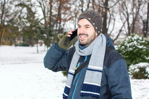 Bearded man using cellphone in winter — Stock Photo, Image