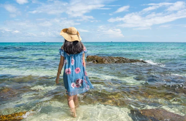 Menina de pé no mar vestindo vestido azul . — Fotografia de Stock