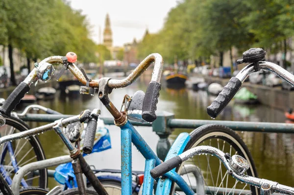 Bicycle parked on a bridge in Amsterdam city center — Stock Photo, Image