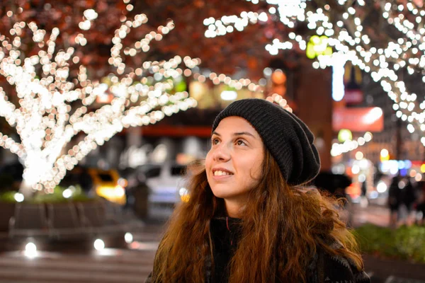 Pretty girl and festive lights — Stock Photo, Image