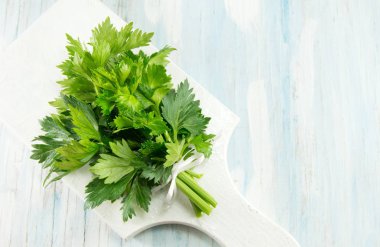 whole celery on a white cutting board clipart