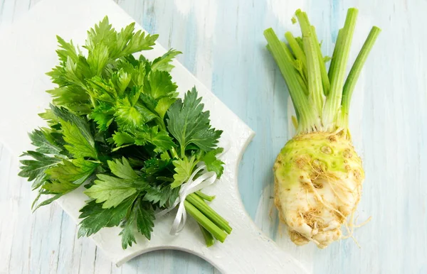 Whole celery on a white cutting board — Stock Photo, Image