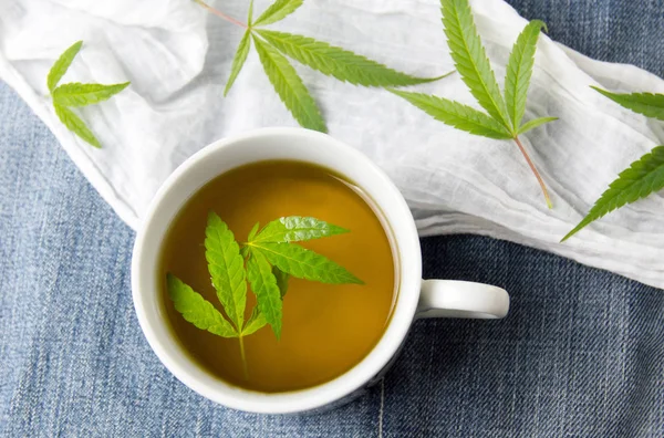 stock image Cannabis herbal tea and marijuana leaves