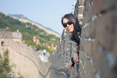 Happy tourist on the Great Wall of China clipart