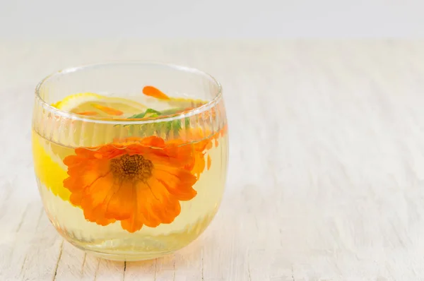 Kadife çiçeği çiçek bitkisel çay limon dilimleri ile — Stok fotoğraf