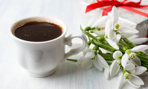 Кава зі сніжками квіти та подарункова коробка — стокове фото