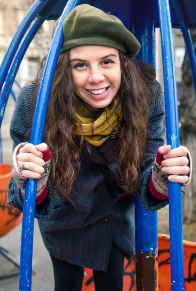 Pretty girl on a toy roundabout in the park — Stock Photo, Image