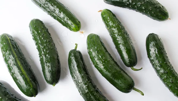 Fresh cucumbers on white wooden table — Stock Photo, Image