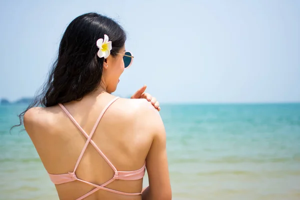 Девушка применяет солнцезащитный лосьон на летних каникулах — стоковое фото