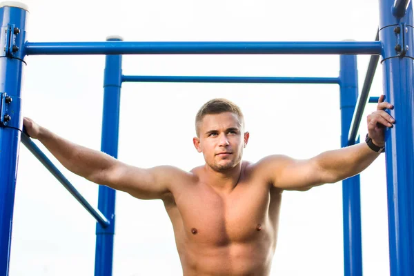 Masculine man in street workout playground