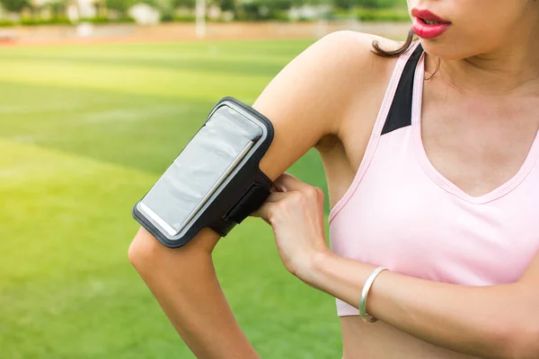 Dziewczyna, Konfigurowanie smartphone do śledzenia aktywności do joggingu — Zdjęcie stockowe