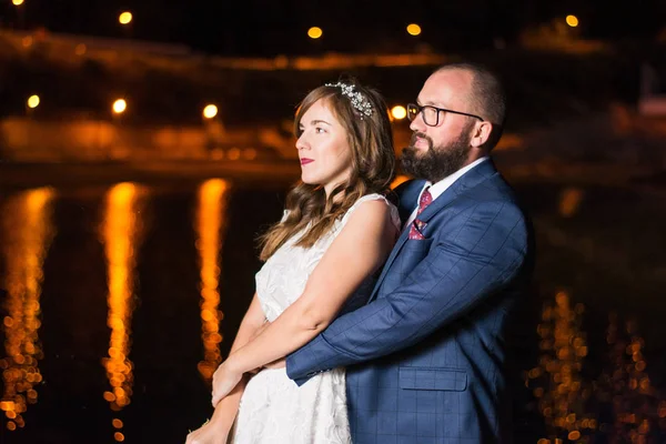 Весільна пара біля озера вночі — стокове фото