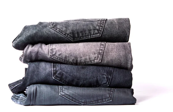 Pile de jeans gris isolé sur blanc — Photo