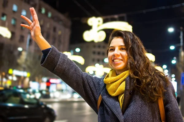 Menina chamando táxi em ambiente urbano — Fotografia de Stock