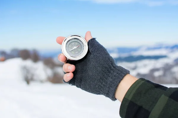 Man holding a metal compass on mountain — Stock Photo, Image