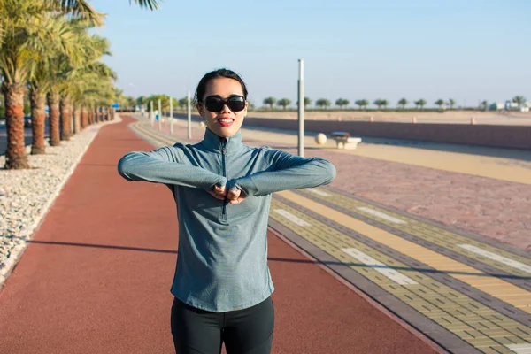 Girl warming up on a running track before workout — Stock Photo, Image