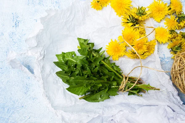 Karahindiba yapraklar ve bir masaya çiçek — Stok fotoğraf