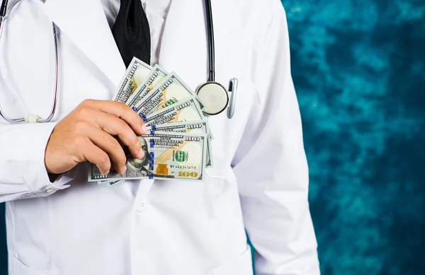 Doctor holding dollar bills close up — Stock Photo, Image