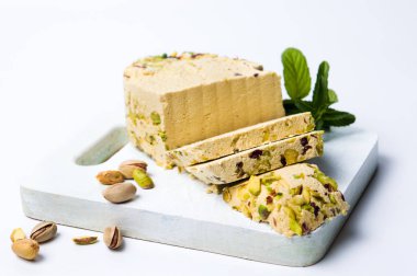 Halva with pistachio on a cutting board isolated clipart